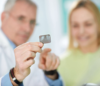 Dentist checking an x-ray with the patient